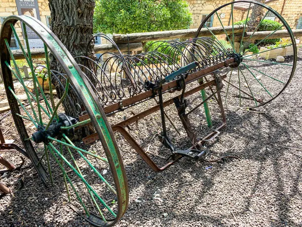 Photo of vintage horse-drawn mechanical hay rake