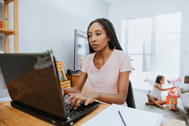 istock Woman working at home with daughter playing 1303521489