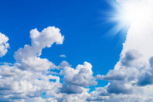 istock Blue sky with white clouds and sun in sunny summer day. 1303524318