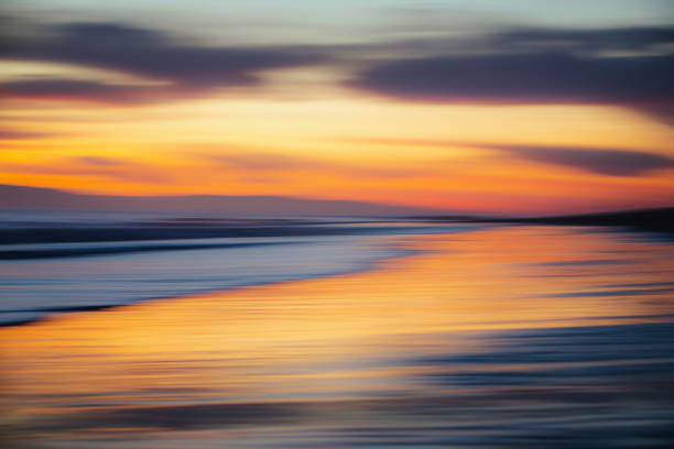 istock Warm golden sky at dusk or dawn light over the ocean 1303525709