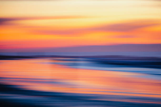 istock Warm golden sky at dusk or dawn light over the ocean 1303526730