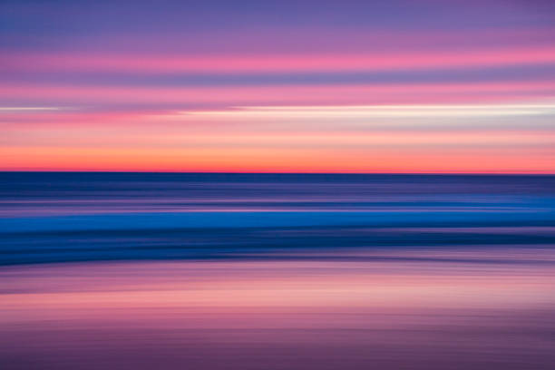 istock Warm pink colors at dusk or dawn light over the ocean 1303527258