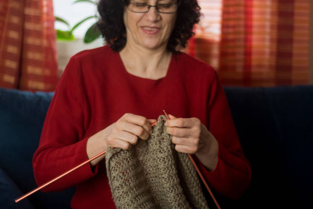 istock Senior woman knitting 1303528731