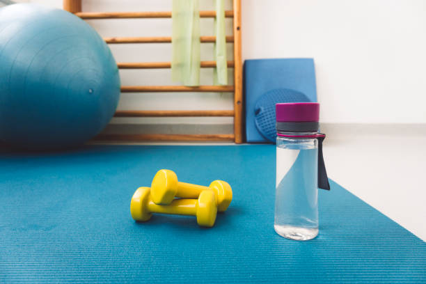 istock Exercise mat, plastic water bottle on yoga mat, no people 1303528775