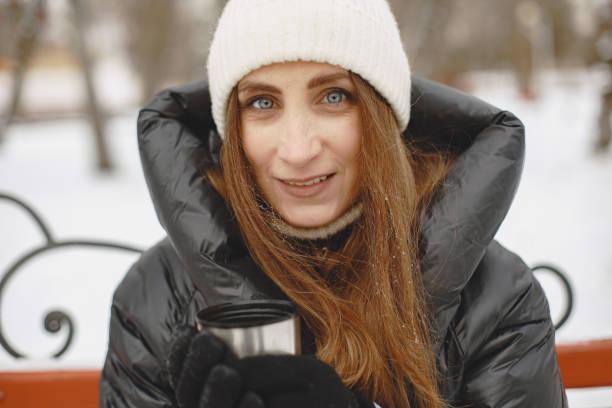 istock Elegant woman in a winter park 1303528800