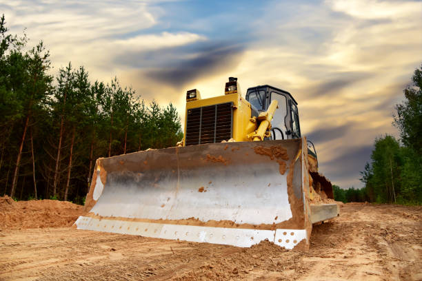 istock Dozer during clearing forest for construction new road. Bulldozer at forestry work on sunset background. 1303529613