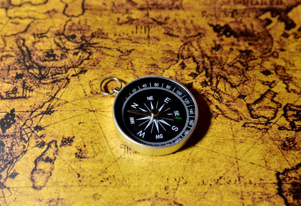istock Compass on map. Tourist compass for orientation on the terrain. Magnetic declination calculator. 1303530362