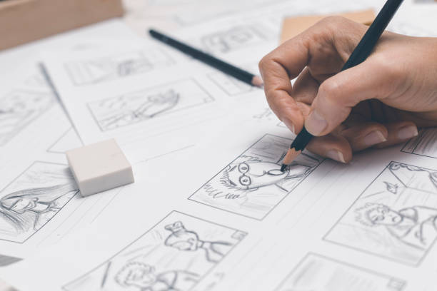 la mano della donna disegna uno storyboard per un film o un cartone animato. l'animatore crea schizzi per i fumetti. - copione foto e immagini stock