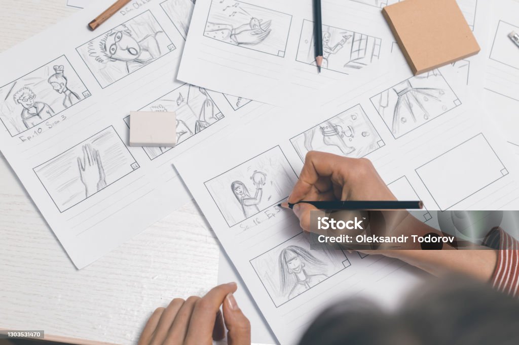 Woman draws storyboard sketches for comics or film. Storyboard Stock Photo