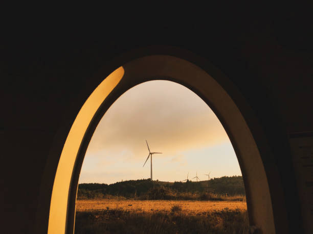 Wind farm at sunrise. Wind turbine Door entrance. Renewable energy concept.