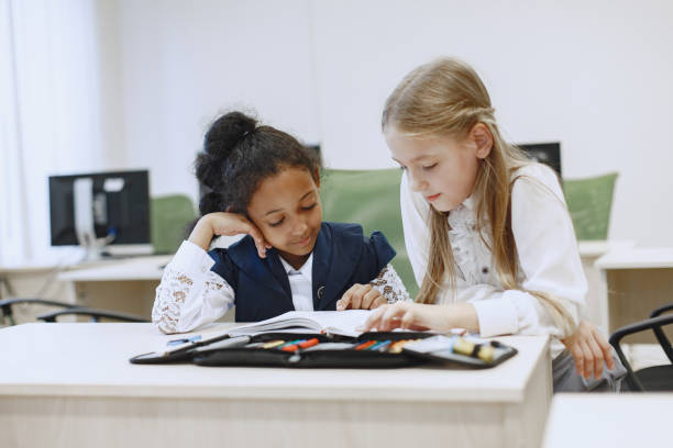 istock Two beautiful girls paint a notebook. 1303532597
