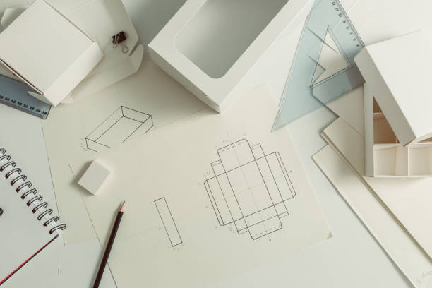 Designer draws a mockup for crafting eco cardboard box. Development a sketch of paper packaging.