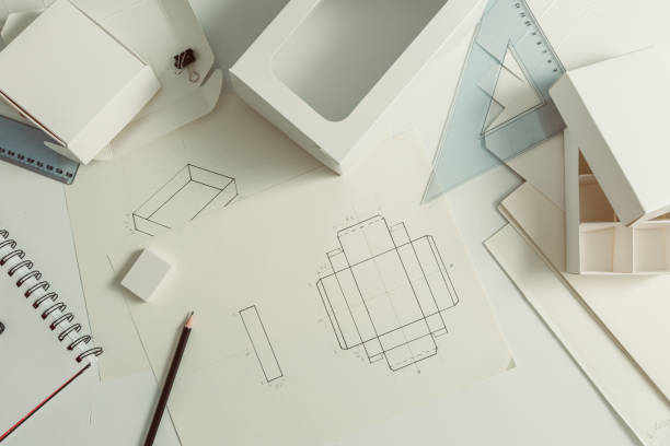 Designer draws a mockup for crafting eco cardboard box. Development a sketch of paper packaging. Designer draws a mockup for crafting eco cardboard box. Development a sketch of paper packaging. product designer photos stock pictures, royalty-free photos & images