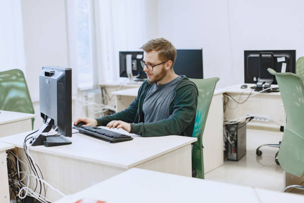 istock Man with glasses is sitting at the computer. 1303532896
