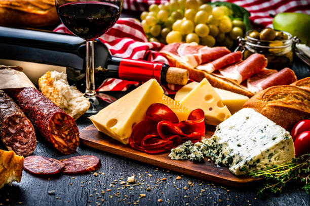 istock Mediterranean food: Iberico ham, Spanish chorizo, cheeses and red wine on dark table 1303532982