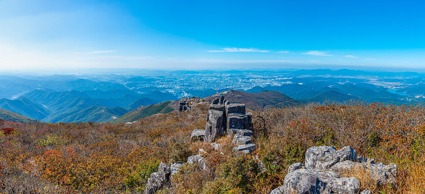 Gwangju viewed behind rocks of Jusangjeolli Cliff at Mudeungsan Mountain, Republic of Korea