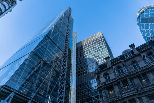 dramatic skyline showing modern office buildings in the city of london. - city of london office building construction architecture imagens e fotografias de stock