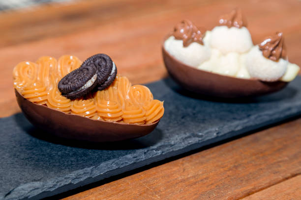 istock Chocolate easter eggs on top of black stone with wooden background 1303535599