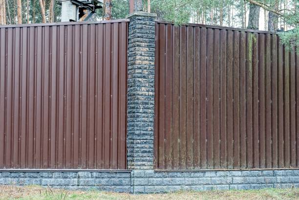 istock brown metal wall fence and gray bricks 1303536119