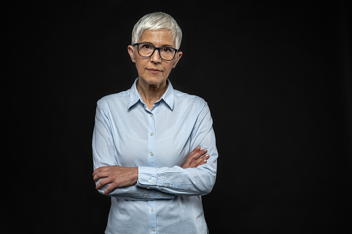 Senior female in business attire. Business executive. Senior lady with grey hair and glasses. Angry teacher. Serious look. Senior entrepreneur. Starting business. Angry grandmother. Problems with parents.