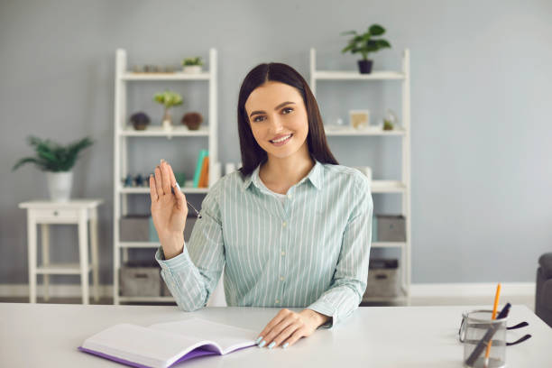 istock Friendly businesswoman participating in online work conference from home. University student taking online class 1303538198
