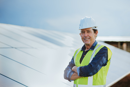 A middle aged man working with solar panel, solar energy