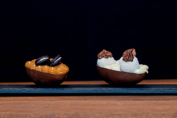 istock Chocolate easter eggs on top of black stone with wooden background 1303540245