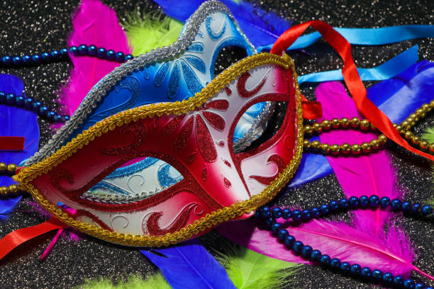 istock Pair Of Face Masks With Feathers And Beads 1303543119