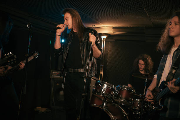 istock Music band performing at rock concert 1303543339