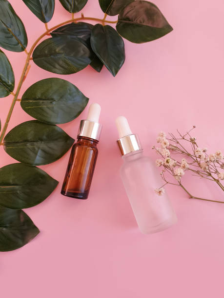 istock cream cosmetic  flower on colored background 1303543547