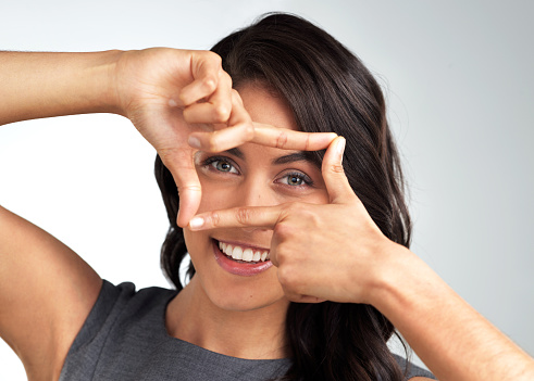 Cropped shot of a beautiful young woman posing against a grey background