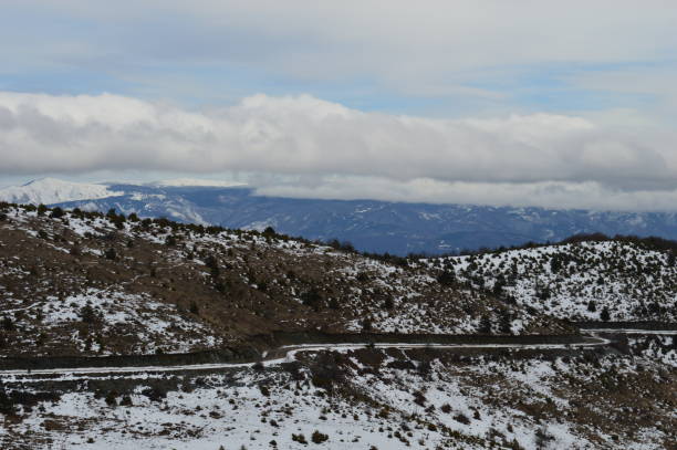 istock mountain road in winter in the snow 1303544436