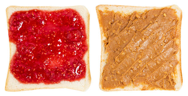 istock Toasts with peanut butter and berry jam isolated on white background. With clipping path 1303546813