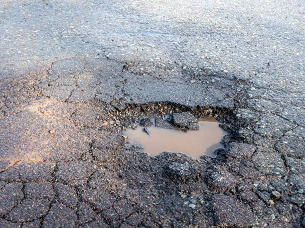 istock Pothole in a road after the frost 1303546854