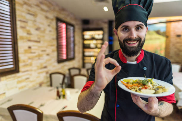 istock Chef holding vegetarian meal 1303547059
