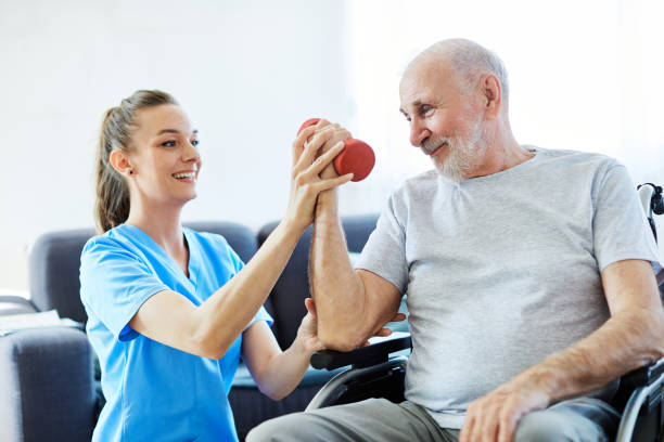 istock nurse doctor senior care exercise physical therapy ecercising help assistence retirement home  elderly man 1303547848