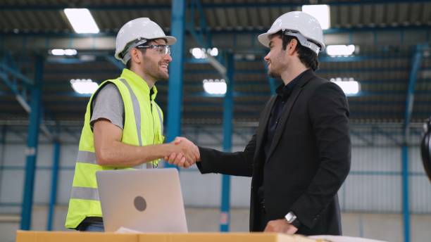istock Two factory workers working and discussing manufacturing plan in the factory . 1303547921