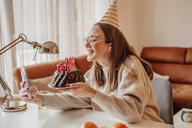 istock Young woman celebrating birthday via video call 1303548155