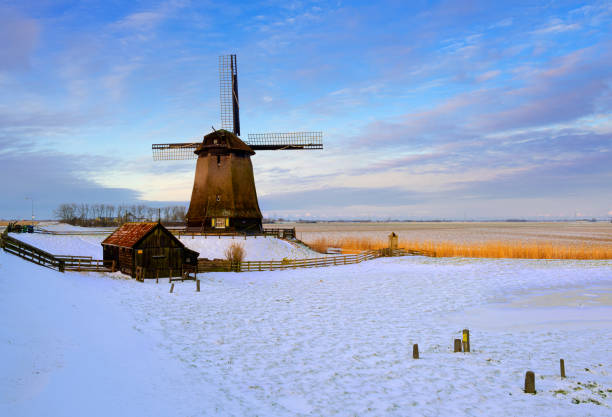 Windmill in winter setting during sunrise. The location is Schermerhorn, Netherlands