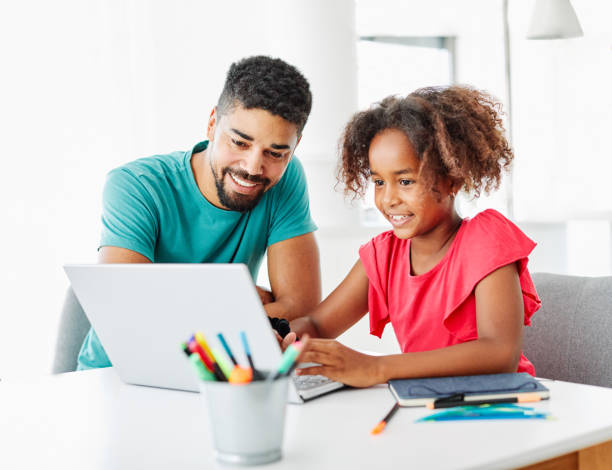 laptop computer education father children daughter girl familiy childhood home child parent homework Father and daughter Having fun with laptop at home homework stock pictures, royalty-free photos & images