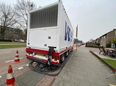 Brunssum, the Netherlands, - February 21, 2021. Emergency generator in action for temporary electrical power supply.