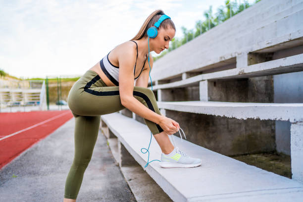 istock Sporty woman tying shoelace 1303552283
