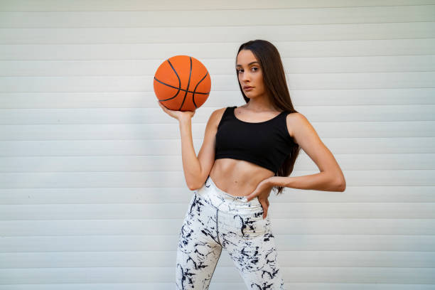 istock young girl posing with basketball ball 1303552363