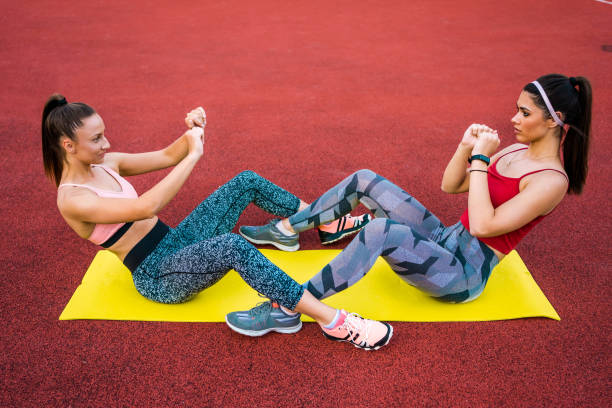 istock Women doing abs outdoor 1303553160