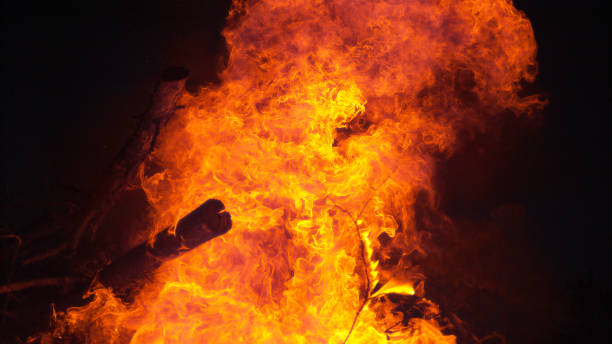 istock CLOSE UP: Beautiful close up shot of a campfire surrounded by complete darkness. 1303553204