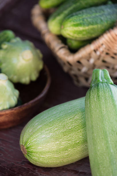 Little girl is holding zucchini in her hand. Close-Up Healthy Eating Concept.