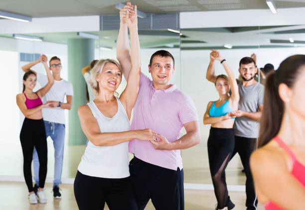 istock Group of  young adults dancing salsa in club 1303553549