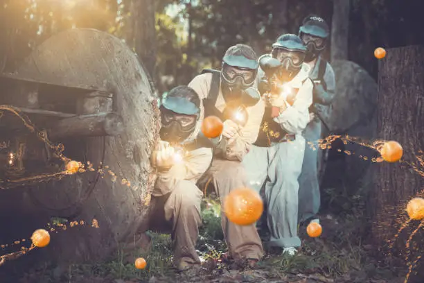 Photo of Paintball team aiming outdoors