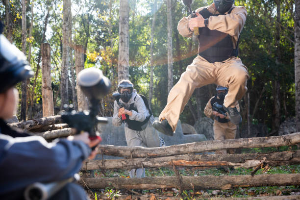 istock People playing paintball outdoors 1303553618