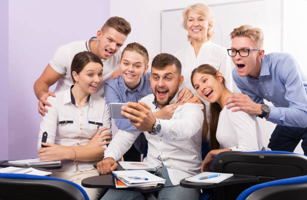 istock students and female professor taking selfie 1303553635